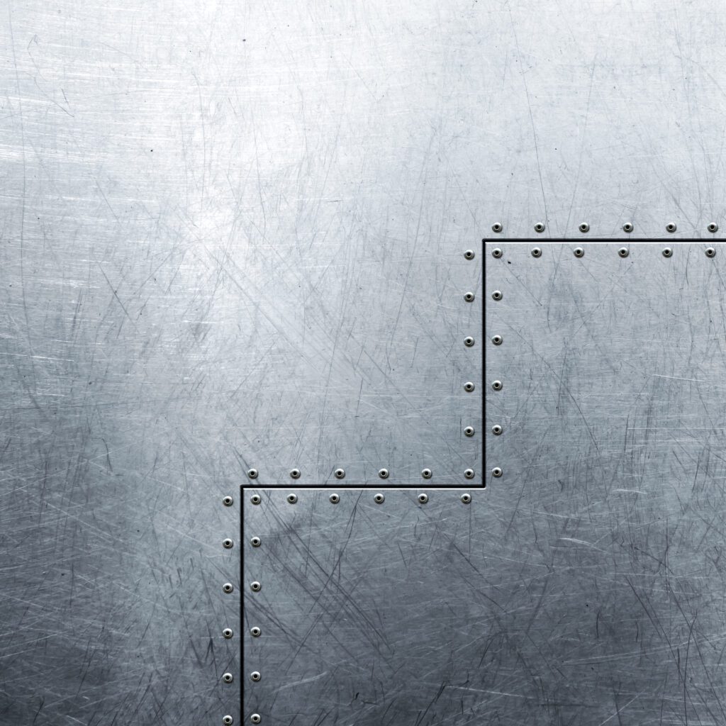 Tekstura metalowej powierzchni z nitami i rysami technicznymi.